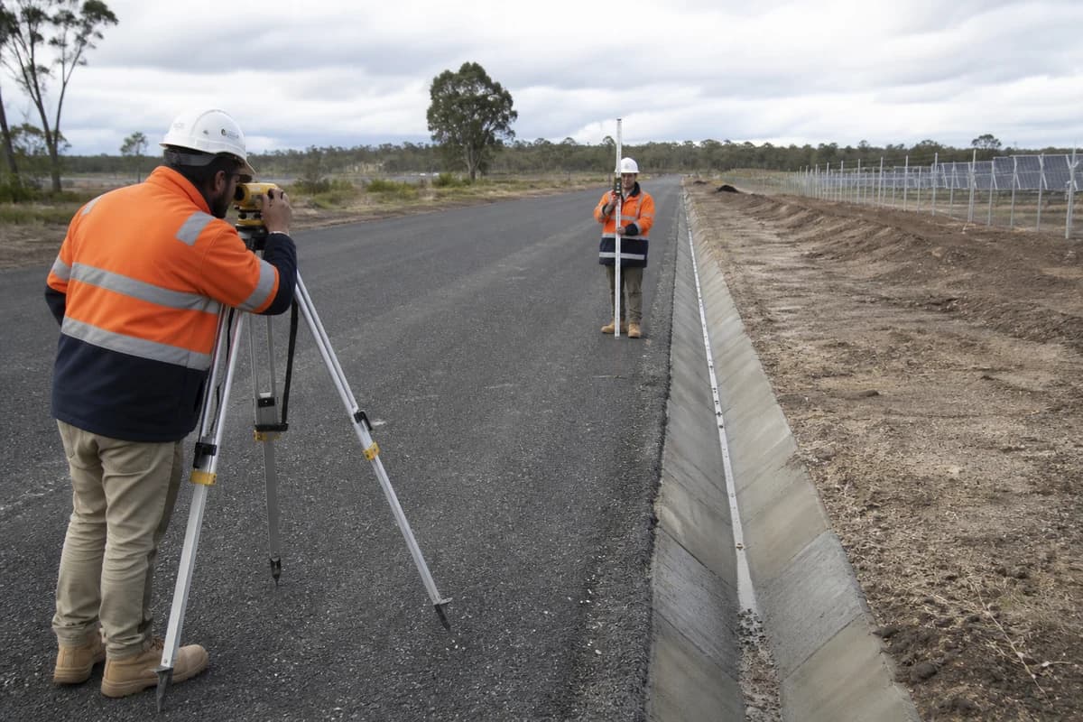 Survey crew checking pavement crossfall to table drain on NSW renewable access road in Australia