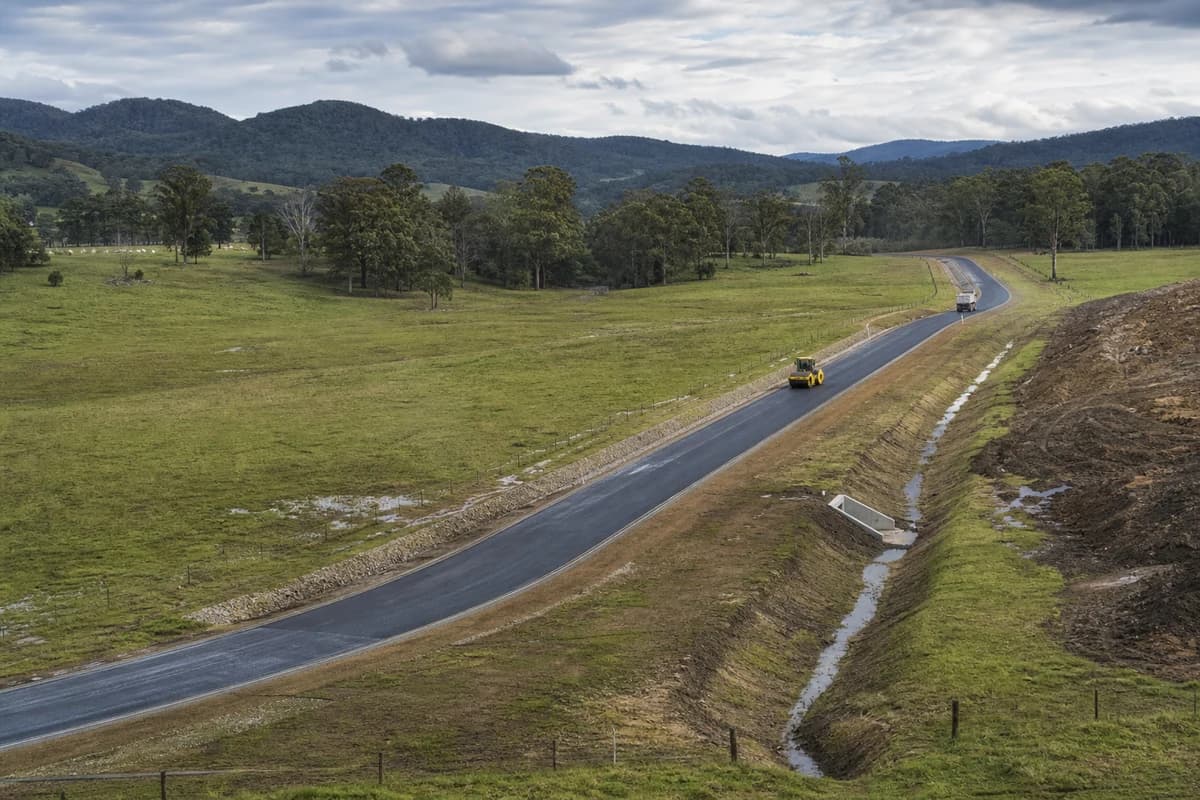 Roadworks Shoalhaven Nowra access road with drainage swales crossing the green Shoalhaven coastal hinterland in NSW
