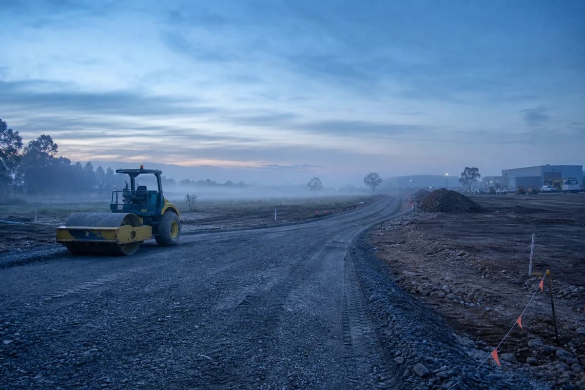 Roadworks Yallah Shellharbour gravel site entry with roller at cool dawn mist on the Illawarra coastal plain
