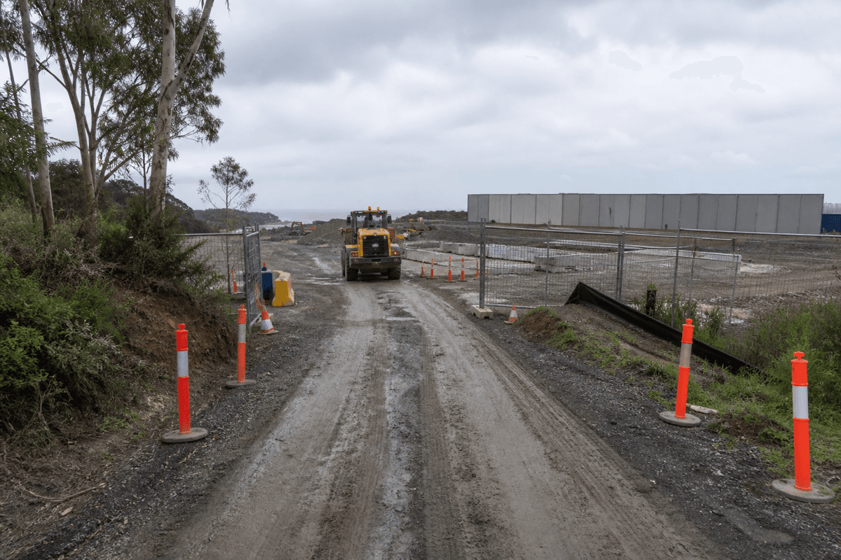 Temporary haul road access gate and Australian earthmoving plant staged at a NSW industrial civil site