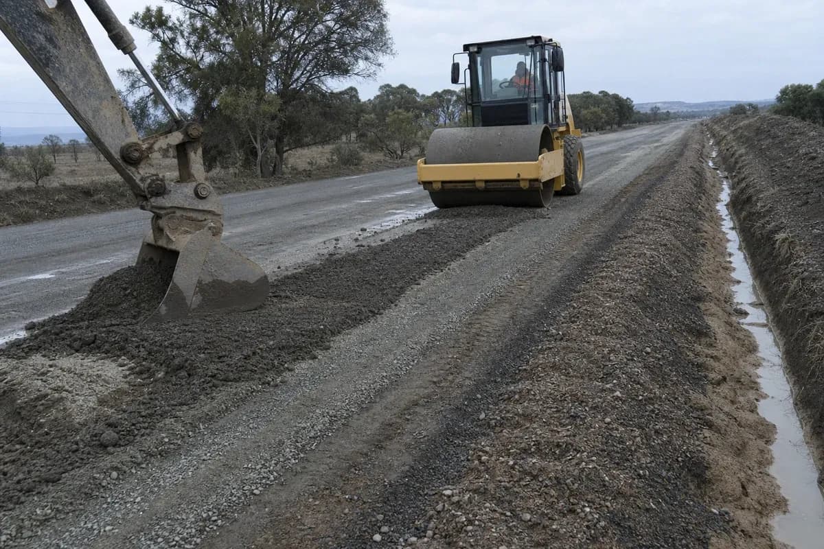 Road drainage contractor interface with haul road construction NSW—rutted gravel dig-out and table drain repair after wet weather
