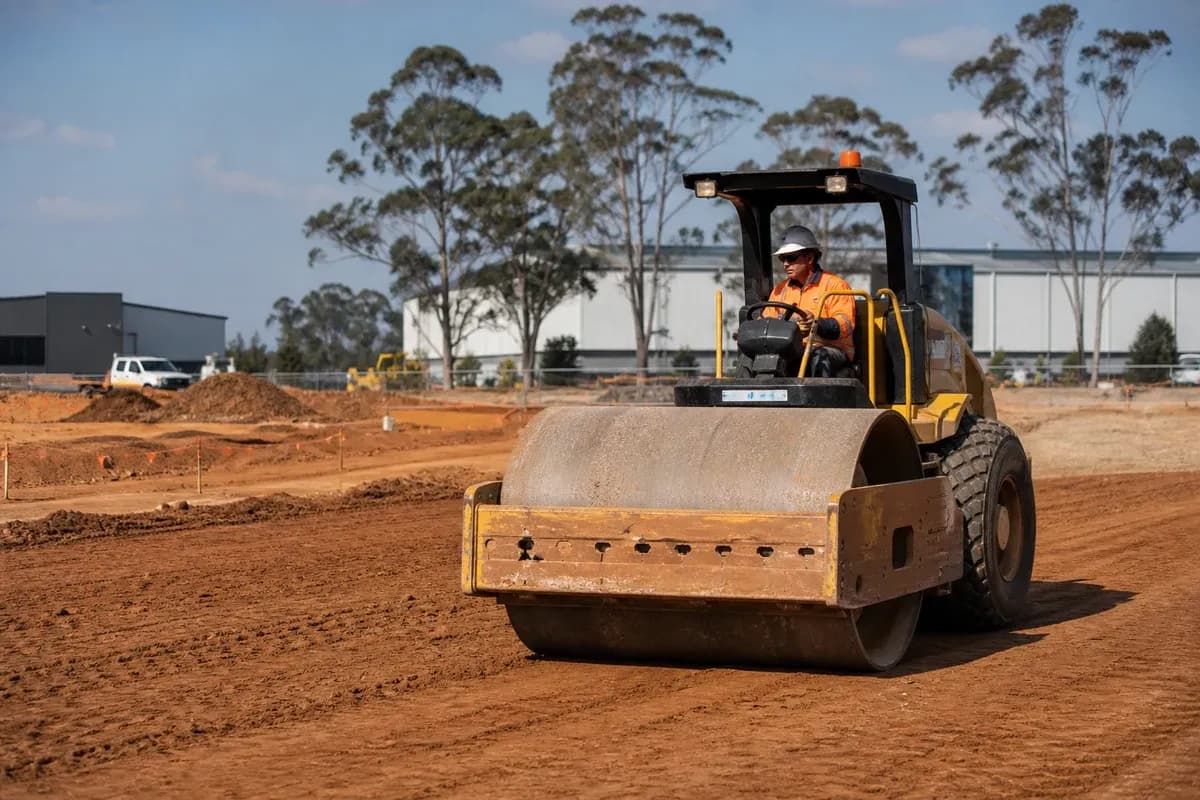 Industrial site development contractor NSW earthworks with roller compacting a warehouse logistics pad on a NSW industrial estate