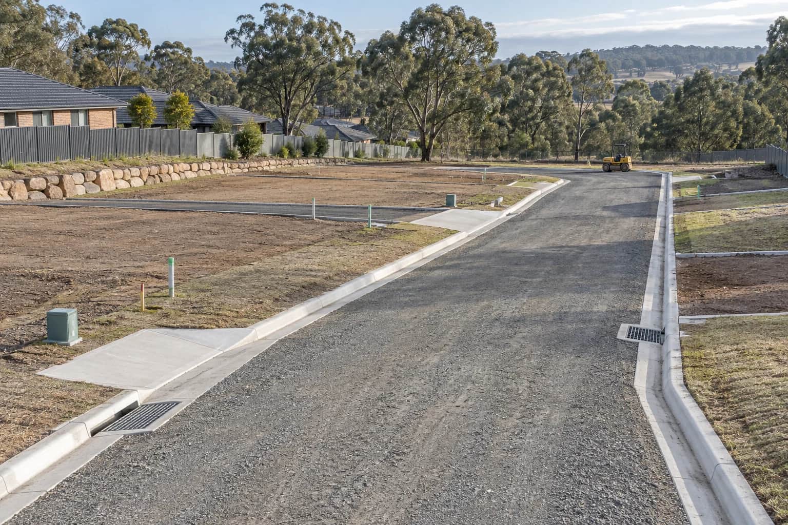 Illustrative subdivision utilities drainage NSW streetscape with serviced lots, kerb inlets, and eucalyptus trees in Australia